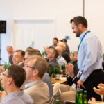 Guests applauding during a corporate conference in Prague