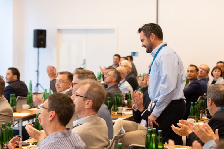 Guests applauding during a corporate conference in Prague