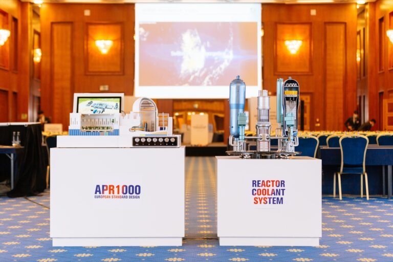 Press conference stage with product models at a Prague industry event