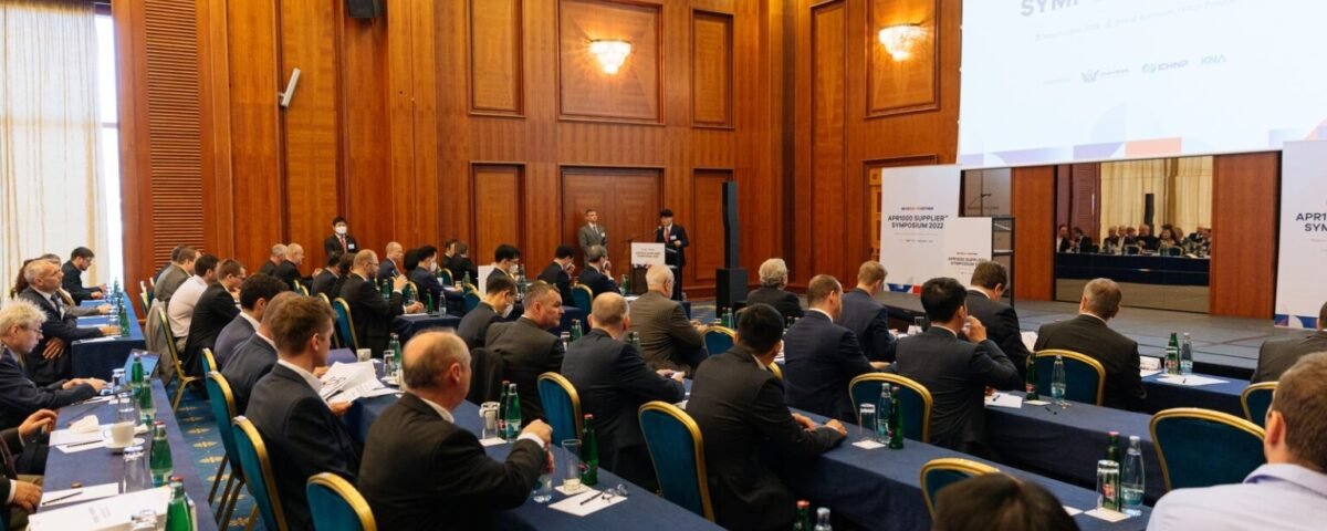 Attendees at a business conference in a wood-panelled Prague venue