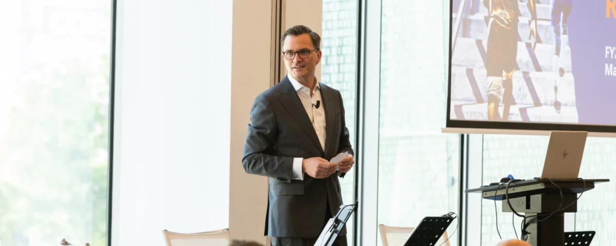 Keynote speaker on stage at a Prague conference venue