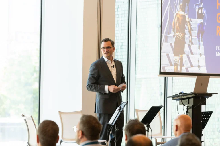 Keynote speaker on stage at a Prague conference venue