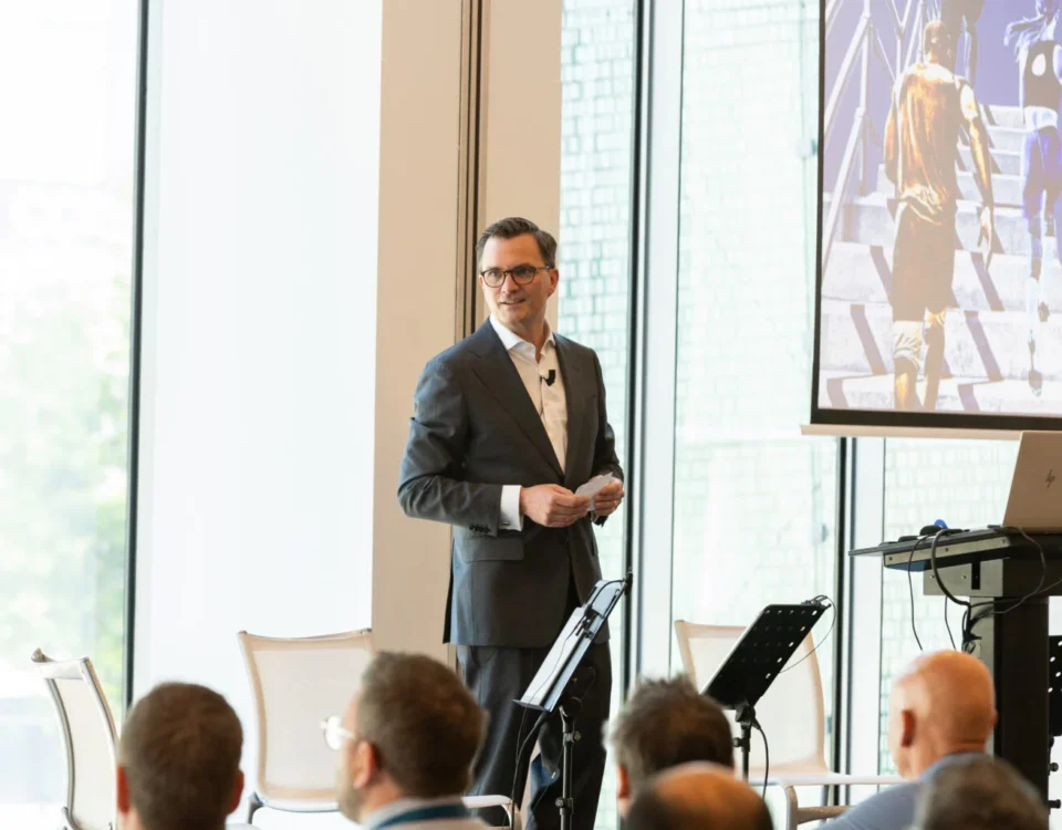 Keynote speaker on stage at a Prague conference venue