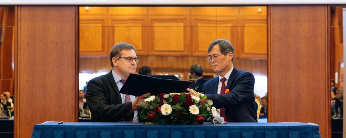 Officials signing an agreement at a diplomatic event in Prague
