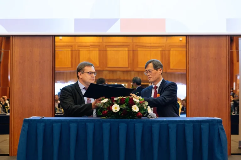Officials signing an agreement at a diplomatic event in Prague