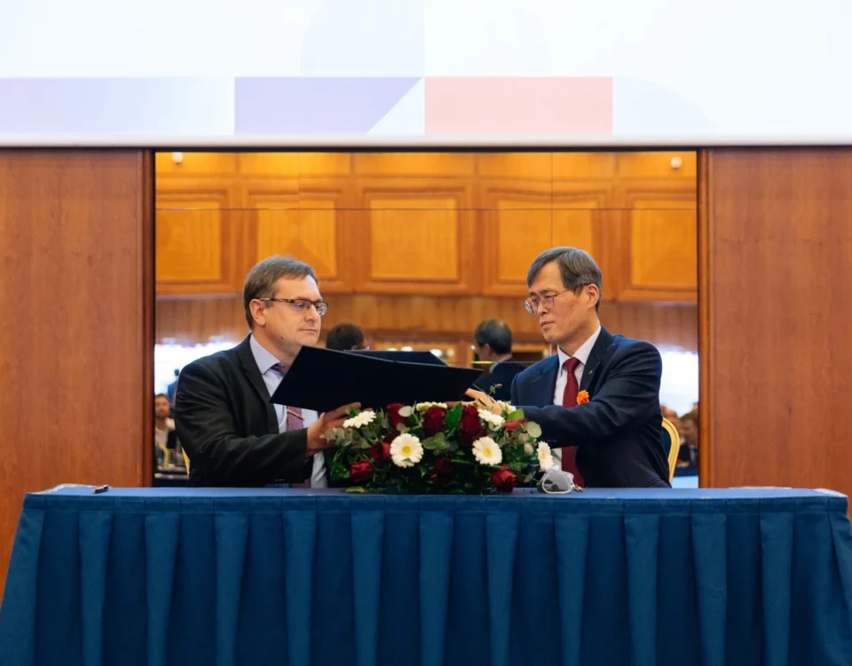 Officials signing an agreement at a diplomatic event in Prague