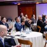 Guests at a corporate dinner presentation in Prague