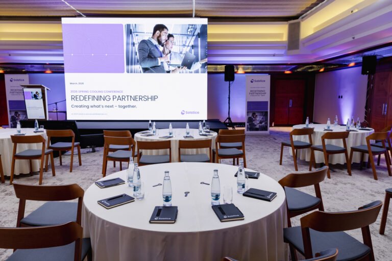 Round-table corporate session with presentation screen in Prague