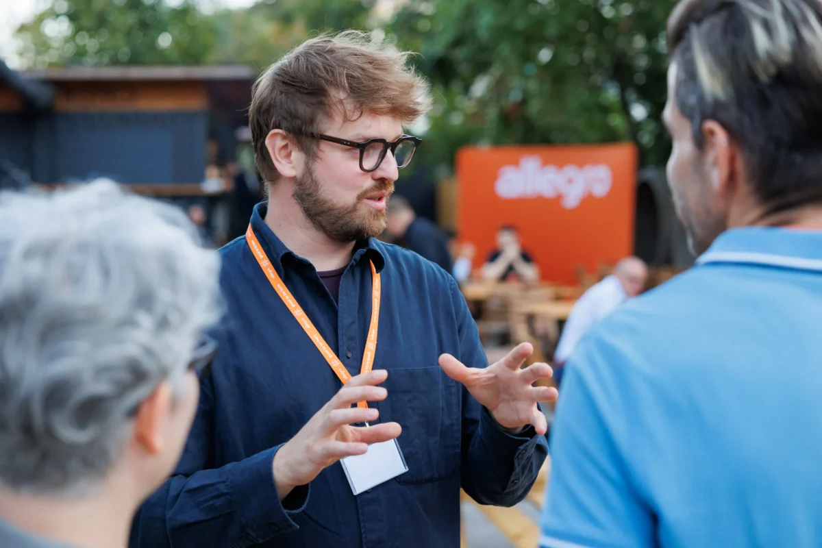 Guests talking outdoors at the Allegro Brand Day in Prague