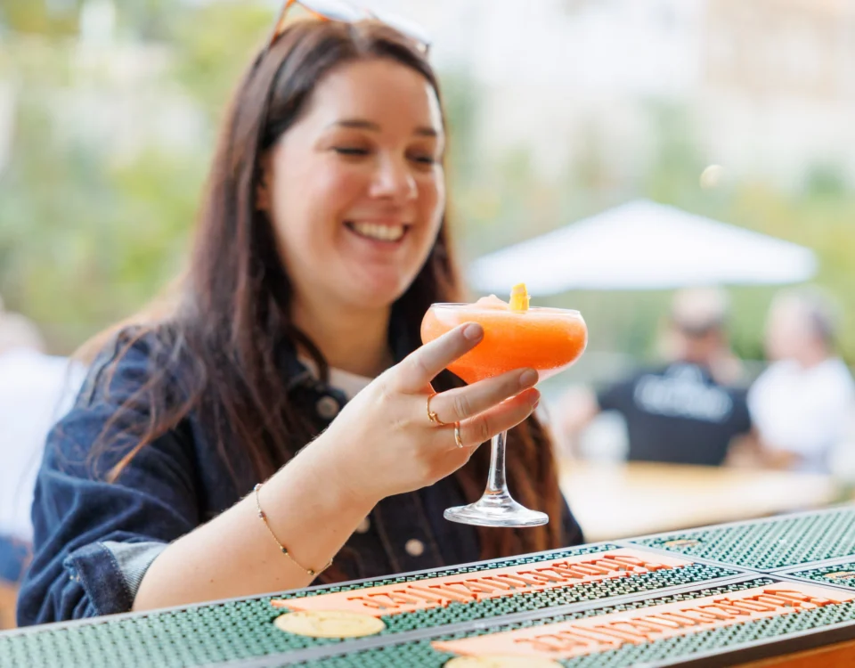Guest with a cocktail at the outdoor reception at the Allegro Brand Day in Prague