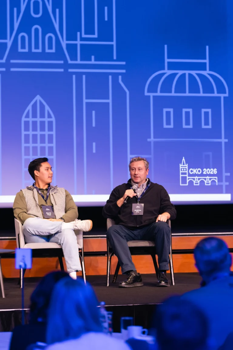 Two panellists on stage during a company kick-off at Hilton Prague Atrium