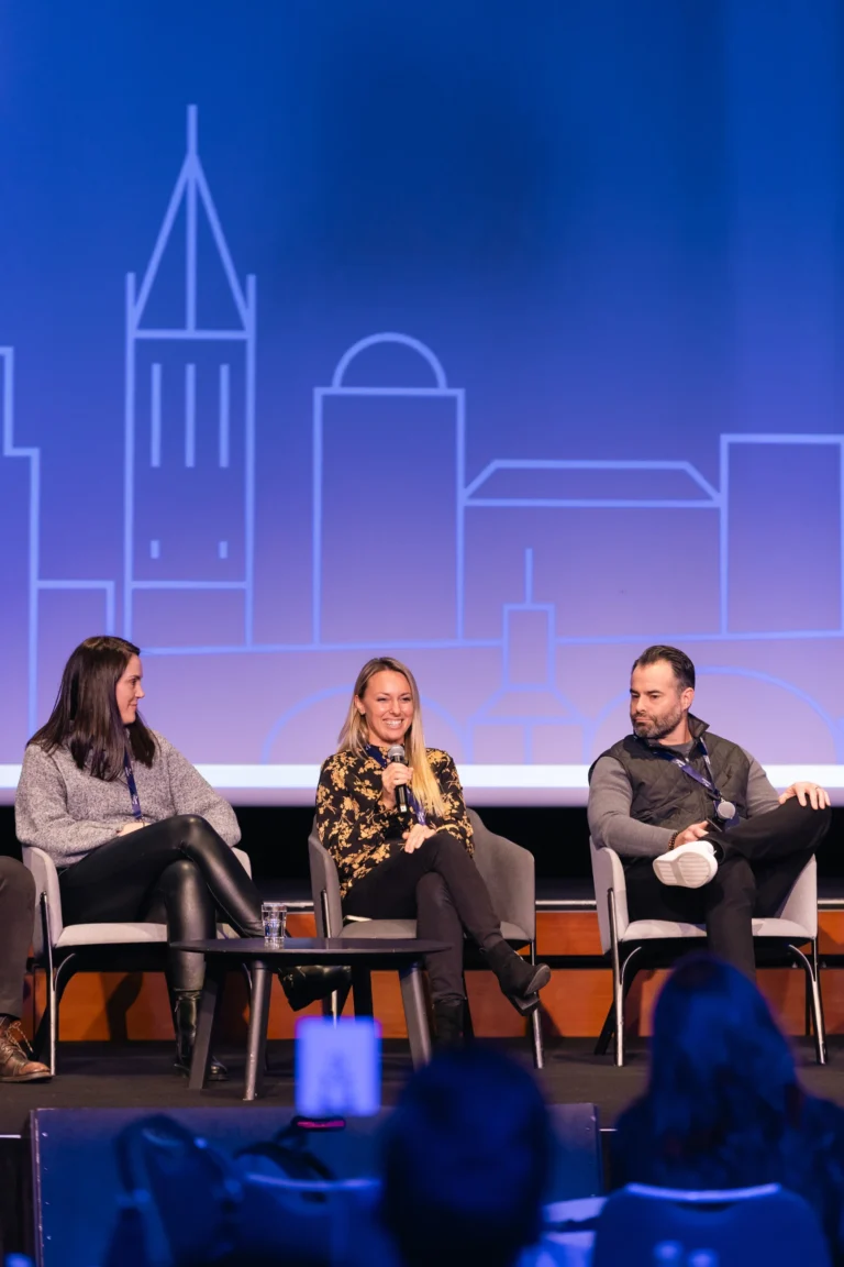 Panel discussion on stage at a company kick-off at Hilton Prague Atrium