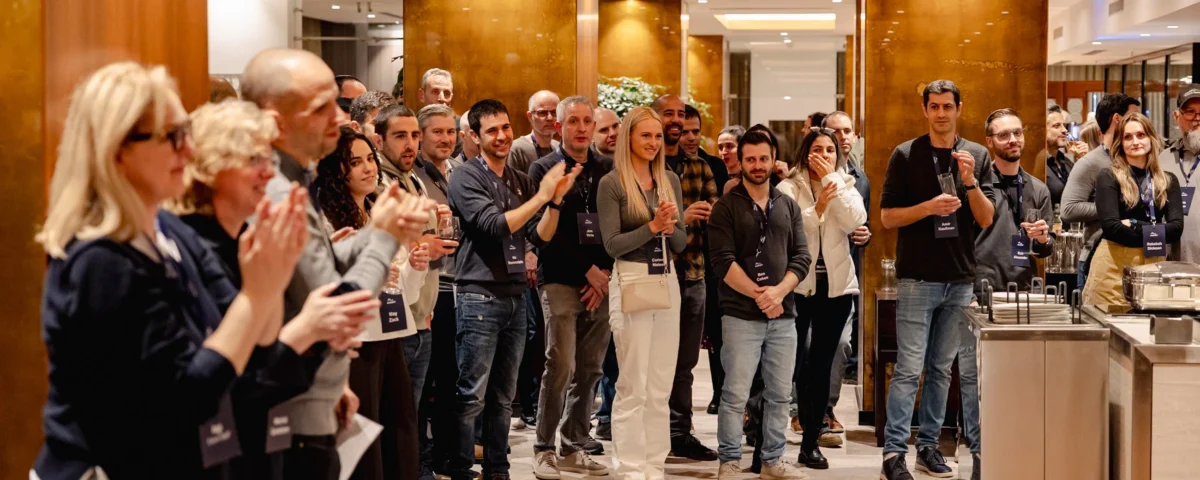 Attendees gathered around a speaker during a break at a company kick-off in Prague