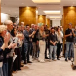 Attendees gathered around a speaker during a break at a company kick-off in Prague