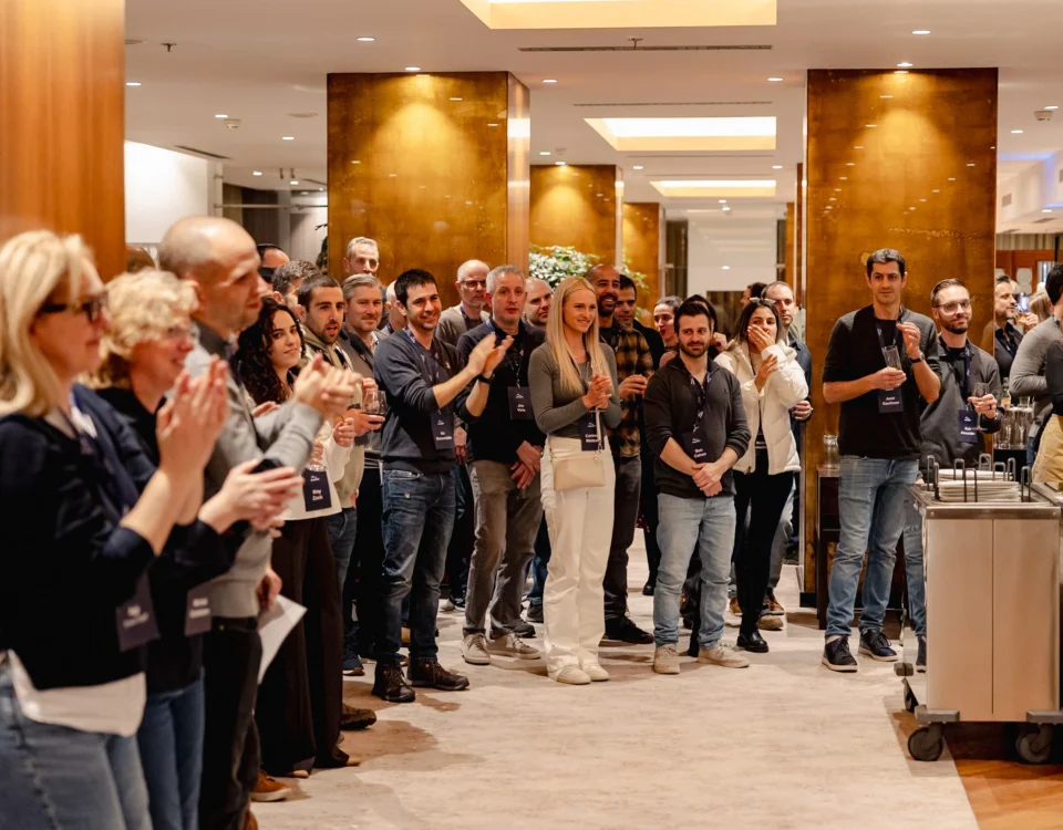 Attendees gathered around a speaker during a break at a company kick-off in Prague