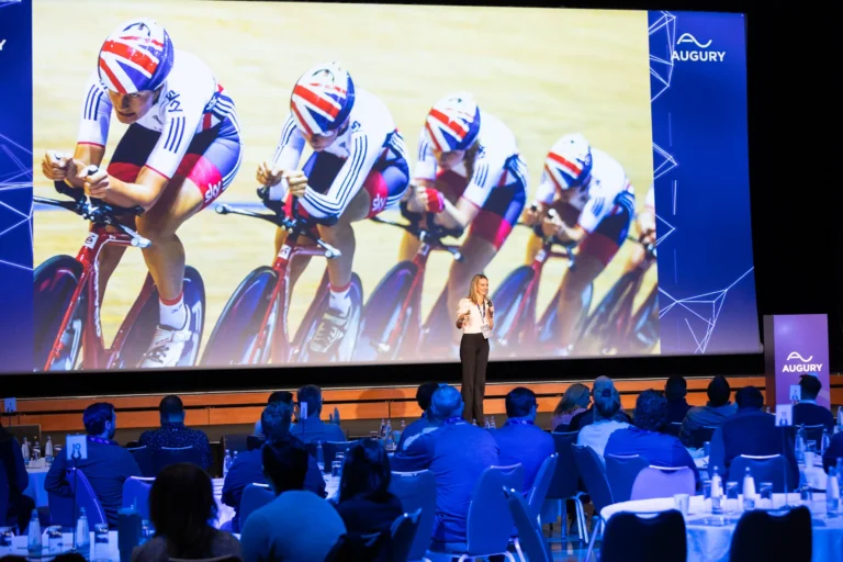 Keynote speaker on stage in the main hall of Hilton Prague Atrium