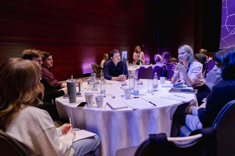 Attendees at round tables during a session at Hilton Prague Atrium
