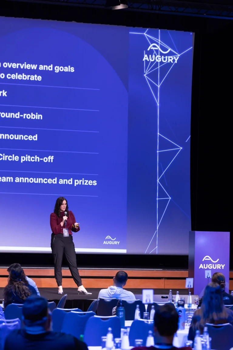 Speaker on stage presenting the programme at Hilton Prague Atrium