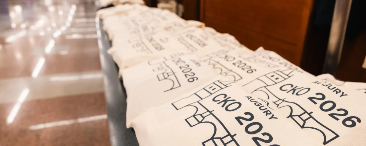 Branded tote bags lined up for attendees at Hilton Prague Atrium