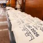 Branded tote bags lined up for attendees at Hilton Prague Atrium