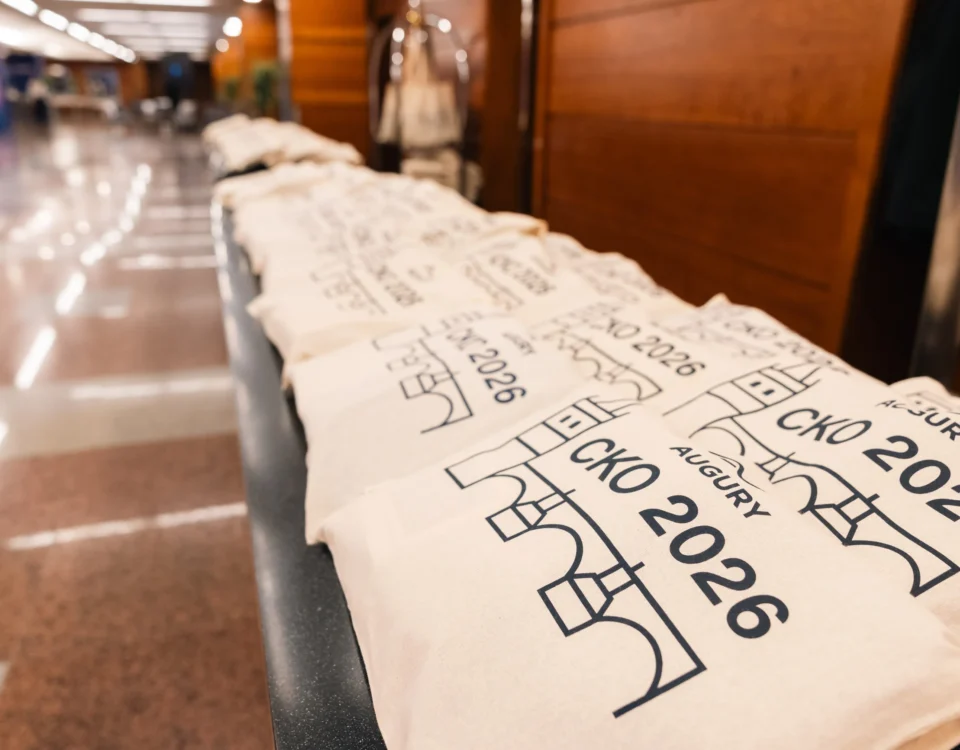 Branded tote bags lined up for attendees at Hilton Prague Atrium