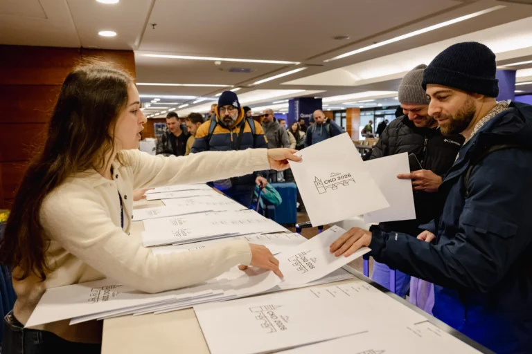 Attendees collecting materials at registration at Hilton Prague Atrium