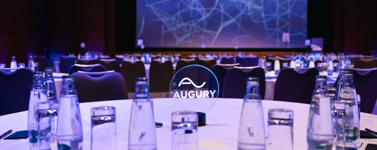 Round tables set in front of the stage in the main hall of Hilton Prague Atrium