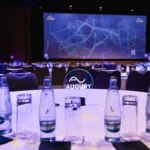 Round tables set in front of the stage in the main hall of Hilton Prague Atrium