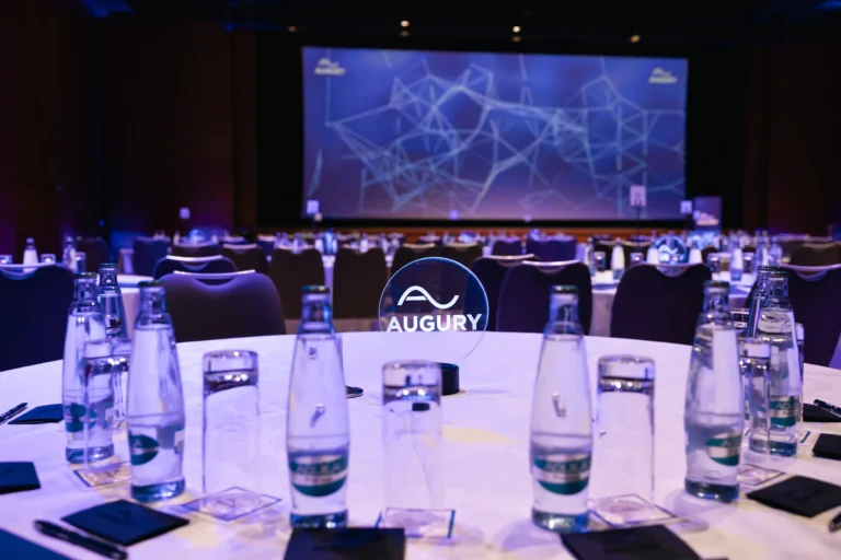 Round tables set in front of the stage in the main hall of Hilton Prague Atrium