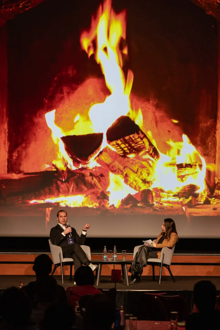 Fireside chat seen from the hall at Hilton Prague Atrium
