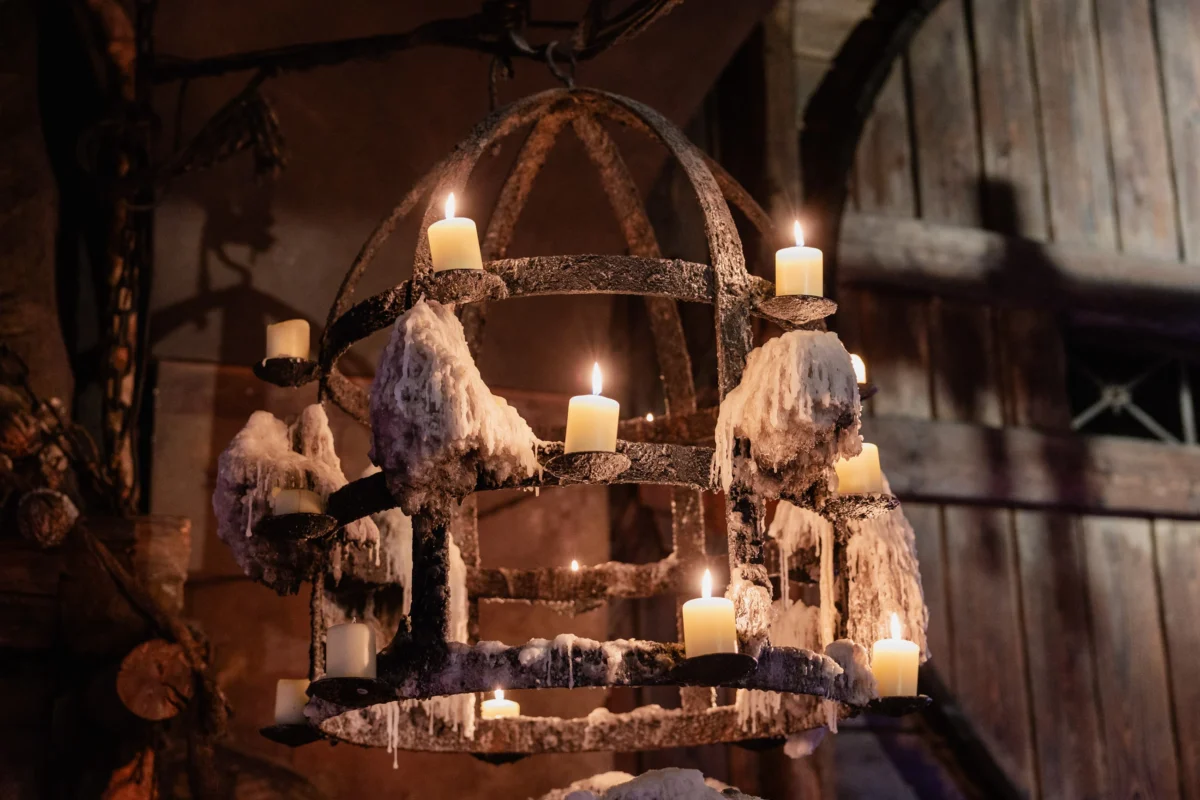 Candle chandelier in a medieval tavern during a company dinner in Prague